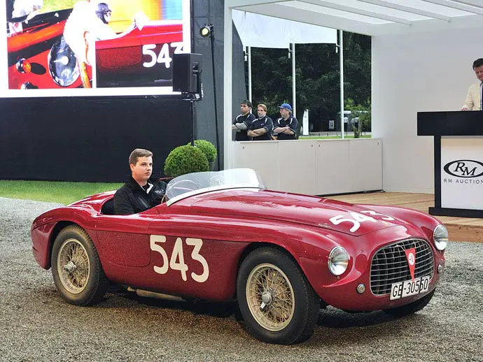 The record-setting 1952 Ferrari 212 Export Barchetta crosses the podium at RM Sotheby’s Villa Erba sale