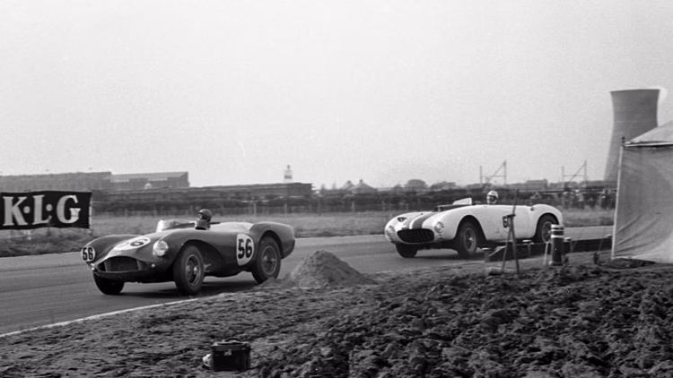 Phil Collins leads in DBS3/2 at Aintree ahead of Masten Gregory in a Ferrari 375 MM.