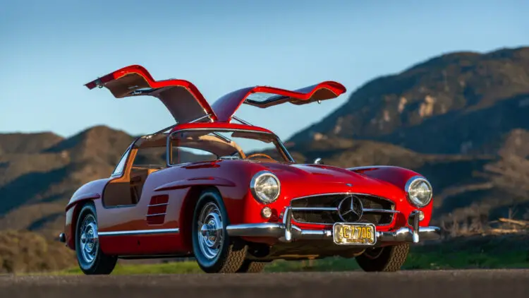 Red 1955 Mercedes-Benz 300 SL Gullwing doors open amongst top cars on sale at Amelia Island 2022