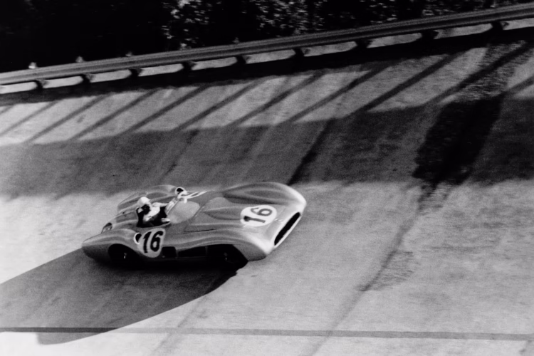 Italy Grand Prix at Monza, 11 September 1955. Stirling Moss in the Mercedes-Benz W 196 R Formula One racing car with a streamlined body (starting number 16) in the banked corner.