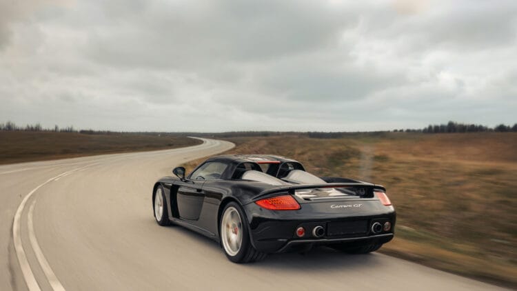 The black 2005 Porsche Carrera GT, seen from the rear, sold for a solid €2,255,000 ($2,643,000) at the RM Sotheby's Monaco 2026 sale